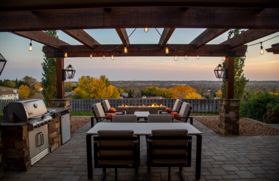 Outdoor dining area with a pergola and scenic view