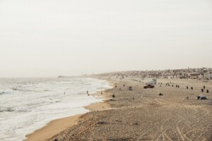 Beach scene with people, sand, and the ocean