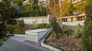 Modern house with driveway and garage on a hillside