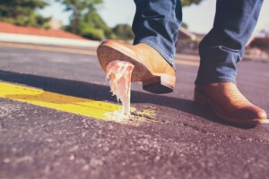 Close-up of a shoe stepping on a piece of gum on the road - Part 2: Hotel Chains Have Lost the Plot: Choosing Lobbying and Profits Over Progress - by Open Air Homes