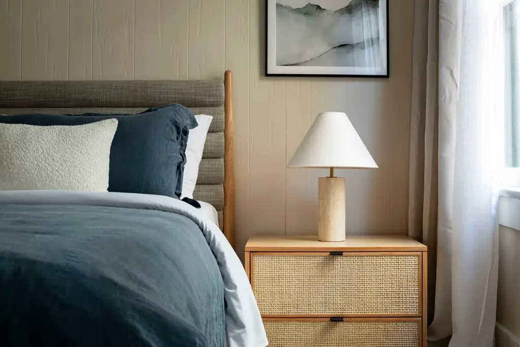 Culver City Airbnb Management - Bedroom with bedside table and lamp, creating a cozy ambiance.