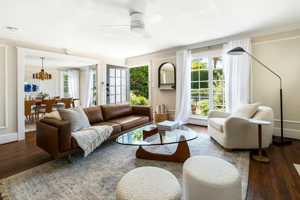 Modern living room with large sofa and outdoor terrace view – by Open Air Homes.