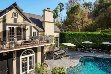 Exterior view of Laurel Canyon Classic Hollywood Residence with pool and outdoor seating by Open Air Homes.