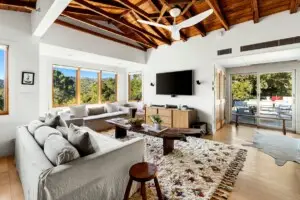 Living room with outdoor patio view at Hillside Hideaway in Topanga Canyon - by Open Air Homes.