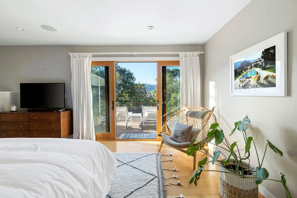 Bright bedroom with outdoor patio view at Hillside Hideaway in Topanga Canyon - by Open Air Homes.