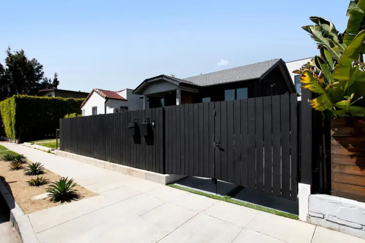 Exterior of Westminster Bungalow with black fence and sidewalk - by Open Air Homes.