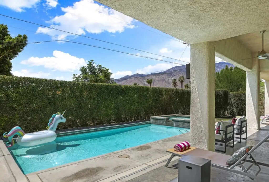Casa Santa Fe Family Home + Pool by Open Air Homes 2 Outdoor area with pool, unicorn float, and mountain view in City Lights Loft – Open Air Homes.