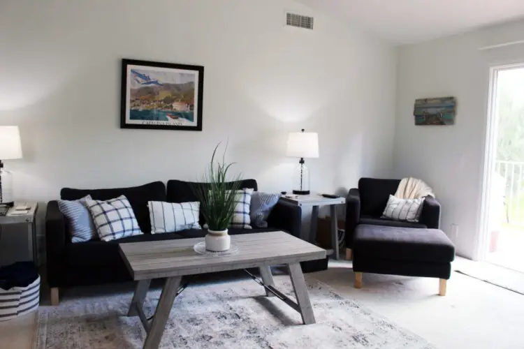 Living room with sofas, coffee table, and decor at Desert Falls - by Open Air Homes