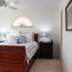 Bedroom with wooden bed and nightstands at Desert Falls by Open Air Homes.