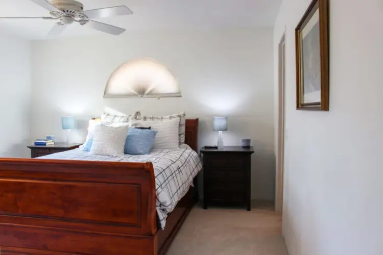 Bedroom with wooden bed and nightstands at Desert Falls by Open Air Homes.