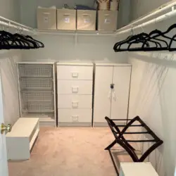 Walk-in closet with storage units, hangers, and shelving at Desert Falls by Open Air Homes.