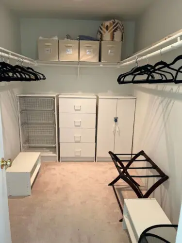 Walk-in closet with storage units, hangers, and shelving at Desert Falls by Open Air Homes.