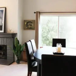 Dining area with round table, chairs, and fireplace at Desert Falls - by Open Air Homes