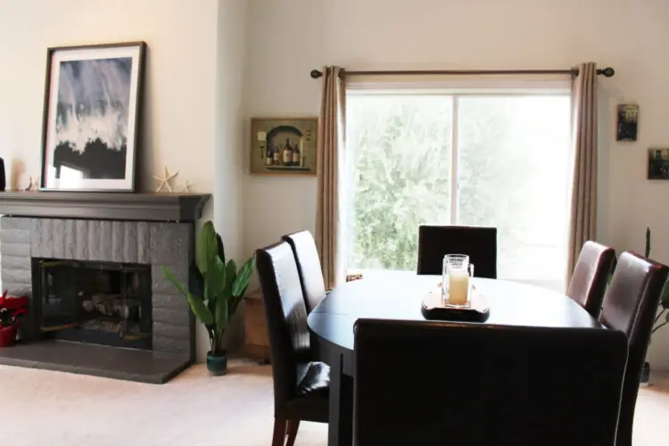 Dining area with round table, chairs, and fireplace at Desert Falls - by Open Air Homes