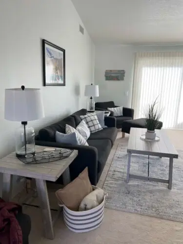 Living room with sofa, coffee table, and decor at Desert Falls - by Open Air Homes