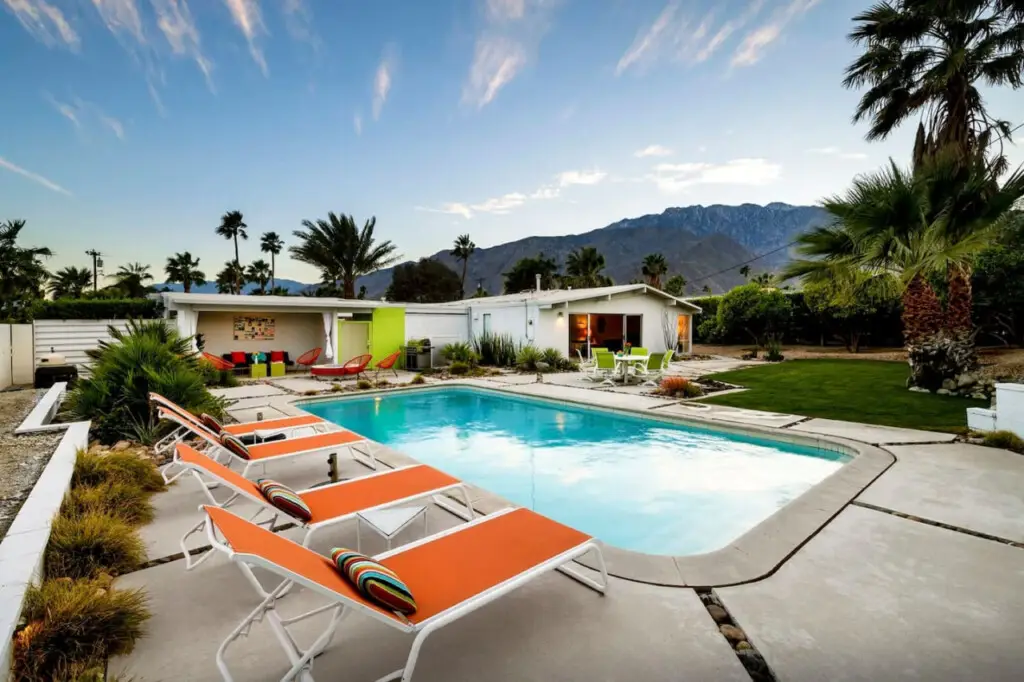 House of the Sun ft. Pool + Hot Tub 4 Outdoor area with pool, lounge chairs, and mountain view in City Lights Loft – Open Air Homes.