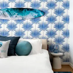 Bedroom with beach-inspired design and surfboard wall decoration at Breathe Malibu - Ocean Front Condo w/ Beach Access by Open Air Homes.