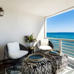 Balcony with seating area overlooking the ocean at Breathe Malibu - Ocean Front Condo w/ Beach Access by Open Air Homes.