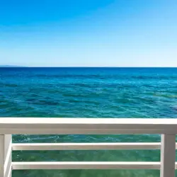 Balcony with outdoor seating overlooking the ocean at Breathe Malibu - Ocean Front Condo w/ Beach Access by Open Air Homes.