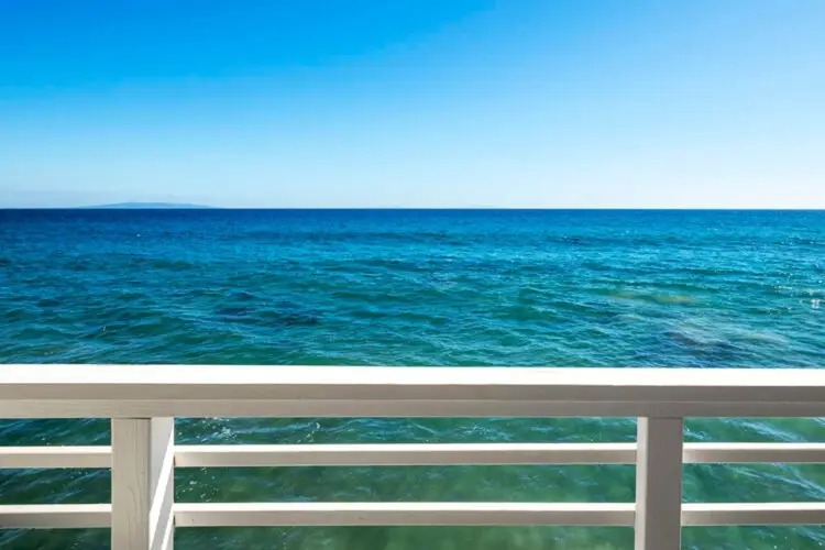 Balcony with outdoor seating overlooking the ocean at Breathe Malibu - Ocean Front Condo w/ Beach Access by Open Air Homes.