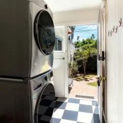 Laundry area with washer and dryer leading to outdoor space at Charming Walk Street Hideaway by Open Air Homes.