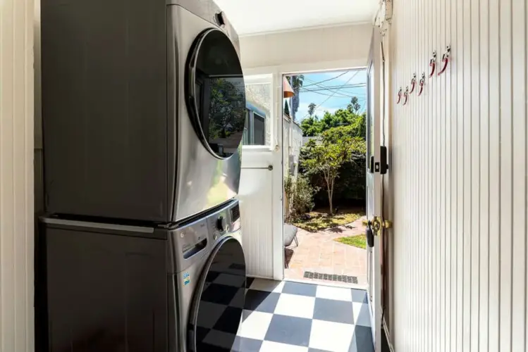 Laundry area with washer and dryer leading to outdoor space at Charming Walk Street Hideaway by Open Air Homes.