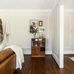 Interior space with leather sofa, console table, and view of another room at Charming Walk Street Hideaway in Venice Beach by Open Air Homes.