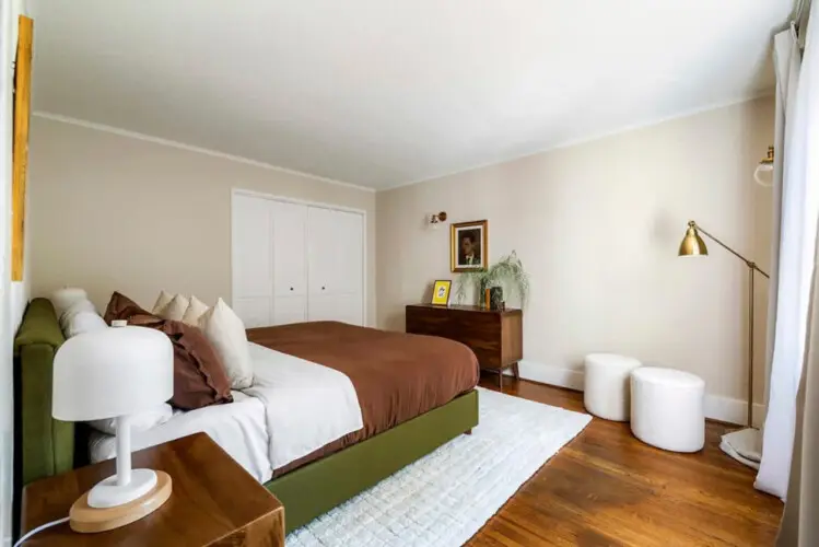 Bedroom with bed, brown bedding, white ceiling, and wooden dresser at Charming Walk Street Hideaway in Venice Beach by Open Air Homes.