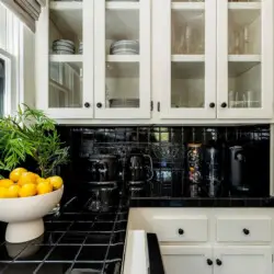 Kitchen counter with a bowl of lemons and a glass vase with greenery at Charming Walk Street Hideaway in Venice Beach by Open Air Homes.