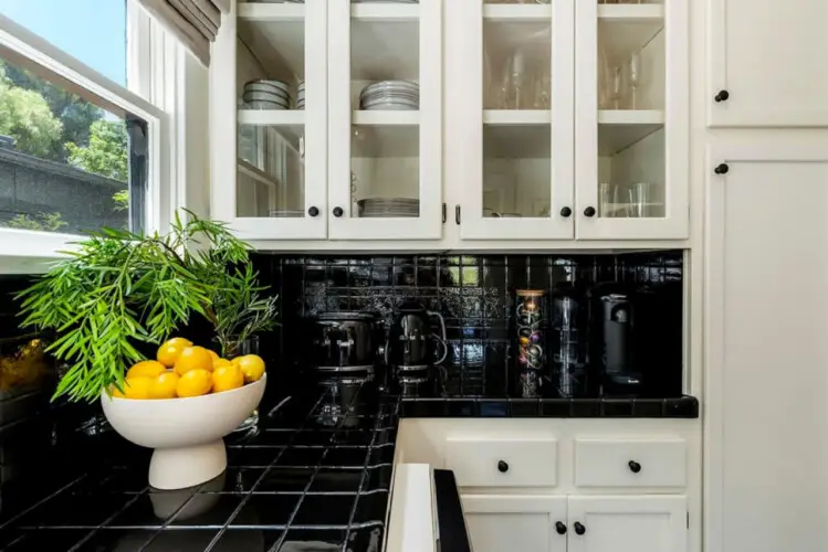 Kitchen counter with a bowl of lemons and a glass vase with greenery at Charming Walk Street Hideaway in Venice Beach by Open Air Homes.