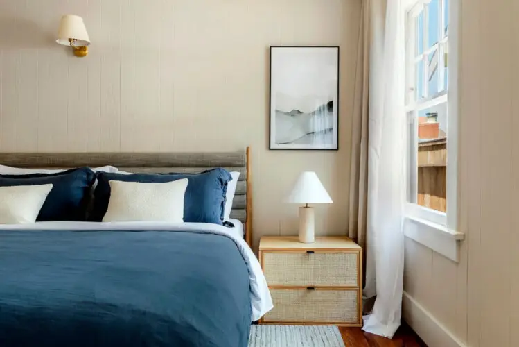 Bedroom with bed, nightstand, and window at Charming Walk Street Hideaway by Open Air Homes.