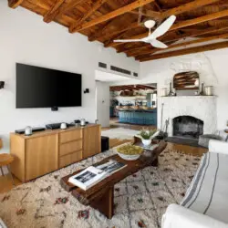 Living room with wooden ceiling and fireplace at Hillside Hideaway in Topanga Canyon - by Open Air Homes