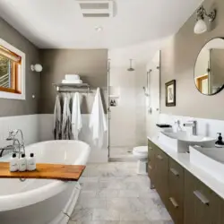 Bathroom with freestanding bathtub, double sink vanity, and walk-in shower at Hillside Hideaway in Topanga Canyon by Open Air Homes.