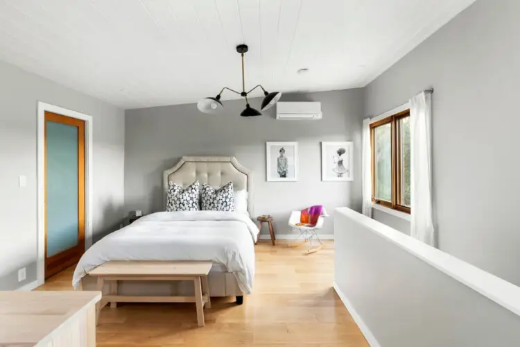 Bedroom with white ceiling, tufted headboard, and framed art at Hillside Hideaway in Topanga Canyon - by Open Air Homes