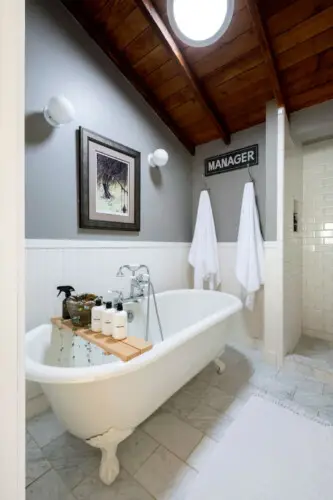 Bathroom with freestanding bathtub, shower area, and towels at Hillside Hideaway in Topanga Canyon by Open Air Homes.