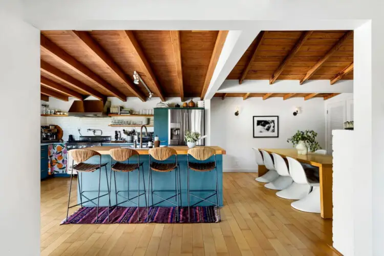 Kitchen with wooden ceiling, blue cabinets, and island at Hillside Hideaway in Topanga Canyon - by Open Air Homes