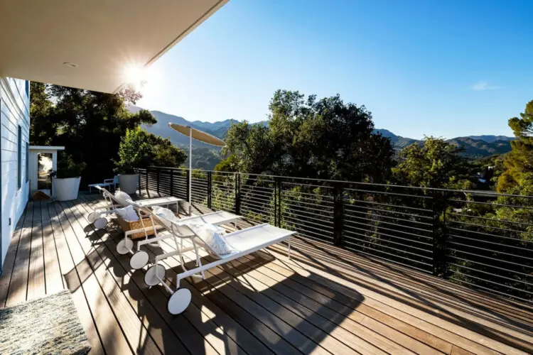 Outdoor deck with loungers at Hillside Hideaway w/ Spa in Topanga Canyon with scenic hill views by Open Air Homes.