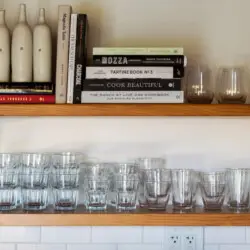 Kitchen shelf with glasses and cookbooks at Hillside Hideaway in Topanga Canyon.