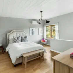 Bedroom with bed and window view at Hillside Hideaway in Topanga Canyon - by Open Air Homes