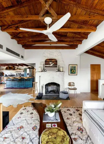 Living room with white fireplace and wooden ceiling at Hillside Hideaway in Topanga Canyon - by Open Air Homes