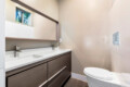 Bathroom with a sink, mirror, and toilet at Ocotillo, Palm Springs