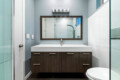 Bathroom vanity with a sink, mirror, and lighting at Ocotillo, Palm Springs