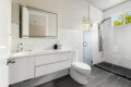 Bathroom with a sink, mirror, and toilet at Ocotillo, Palm Springs