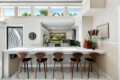 Kitchen with white cabinets, countertop, and bar stools at Ocotillo, Palm Springs