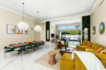 Living room with sofa, coffee table, and large windows at Ocotillo, Palm Springs