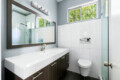 Bathroom with a vanity, sink, mirror, and toilet at Ocotillo, Palm Springs