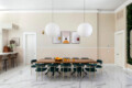 Dining room with a large table, chairs, and pendant lights at Ocotillo, Palm Springs