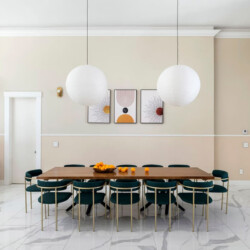 Dining room with a large table, chairs, and pendant lights at Ocotillo, Palm Springs