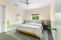 Bedroom with a bed, bedside table, and decorative wall at Ocotillo, Palm Springs