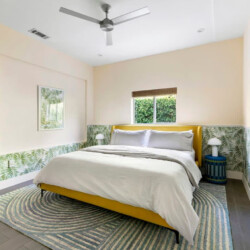 Bedroom with a bed, bedside table, and decorative wall at Ocotillo, Palm Springs